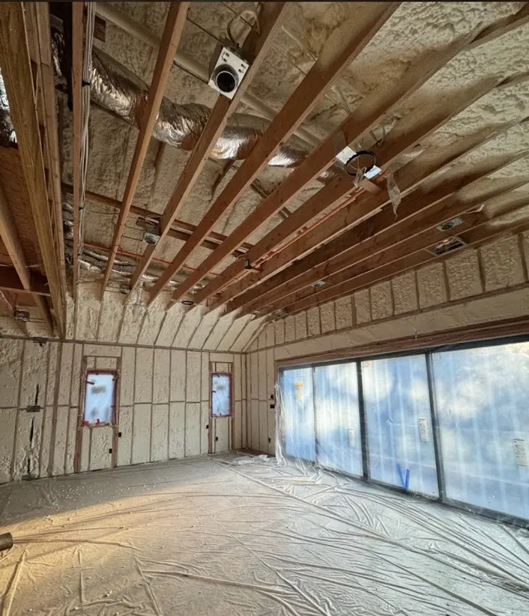 Interior walls and ceiling insulated with spray foam during new construction in West New York